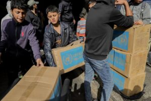 Residents gather around a delivery of aid boxes in Deir al-Balah in Gaza on Jan. 23.